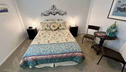 bedroom with duvet table and chair